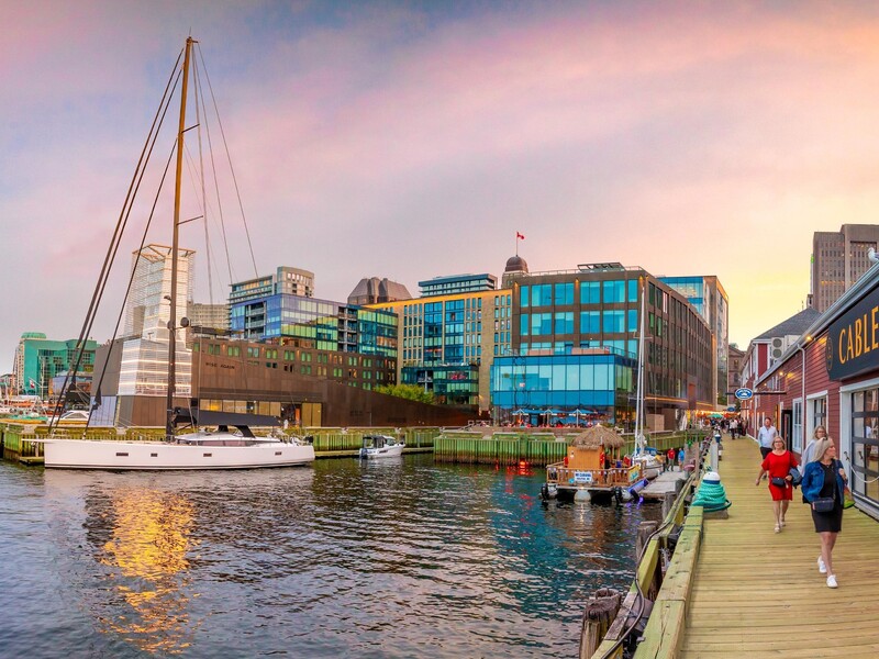 Halifax Waterfront tại Nova Scotia với thuyền buồm, lối đi ven nước và các tòa nhà lúc chiều tà